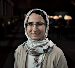 Portrait of Mrs. Jalil smiling in a study hall.